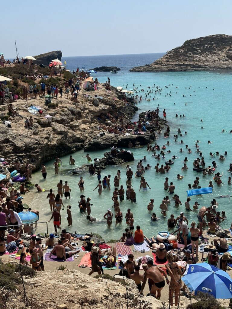 Crowded blue lagoon beach in Malta